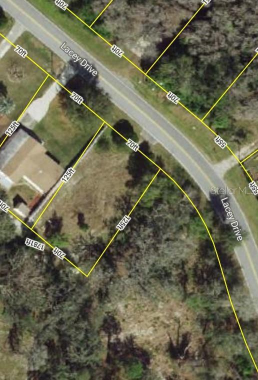 This is an aerial map showing a vacant residential lot outlined in yellow on Lacey Drive — 12272 LACEY DRIVE, NEW PORT RICHEY, FL