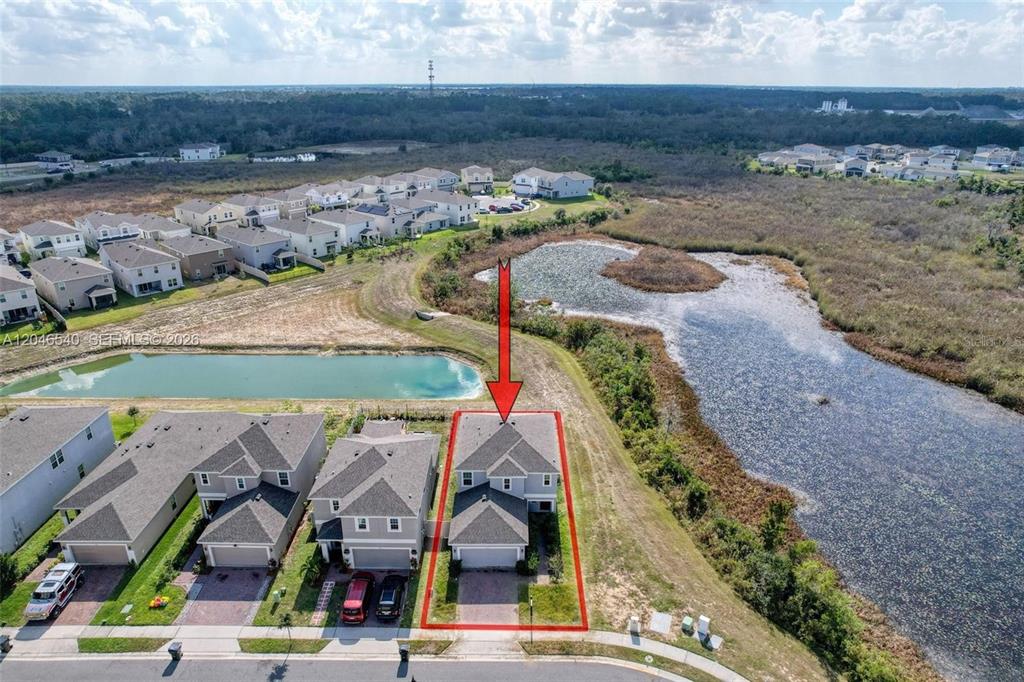 An aerial view shows a suburban house with a red outline, adjacent to a pond — 857 SCRUB OAK HAMMOCK ROAD, DAVENPORT, FL