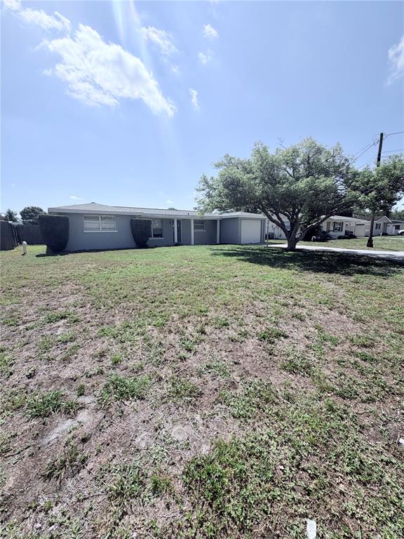 A single-story house with a gray exterior and a large tree in the front yard — 3219 CAMBRIDGE DRIVE, SARASOTA, FL