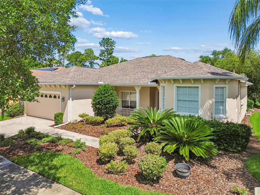 A single-story house with a beige stucco exterior, a paved driveway, and landscaped front yard — 478 BALBOA DRIVE, KISSIMMEE, FL