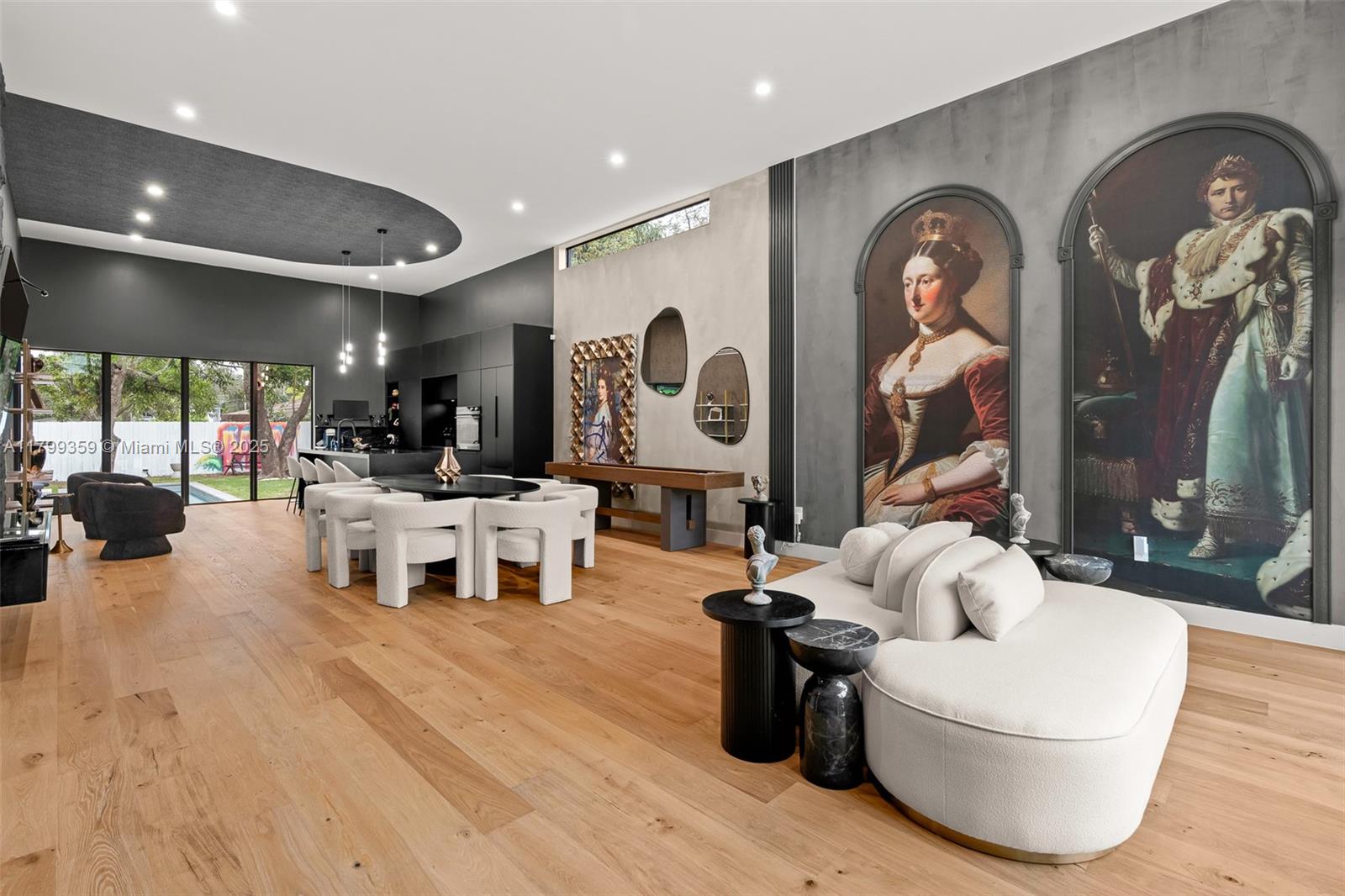 A modern open-concept living and dining area features large wall murals and light wood floors — 400 NW 49th St # 0, Miami FL 33127, MIAMI, FL