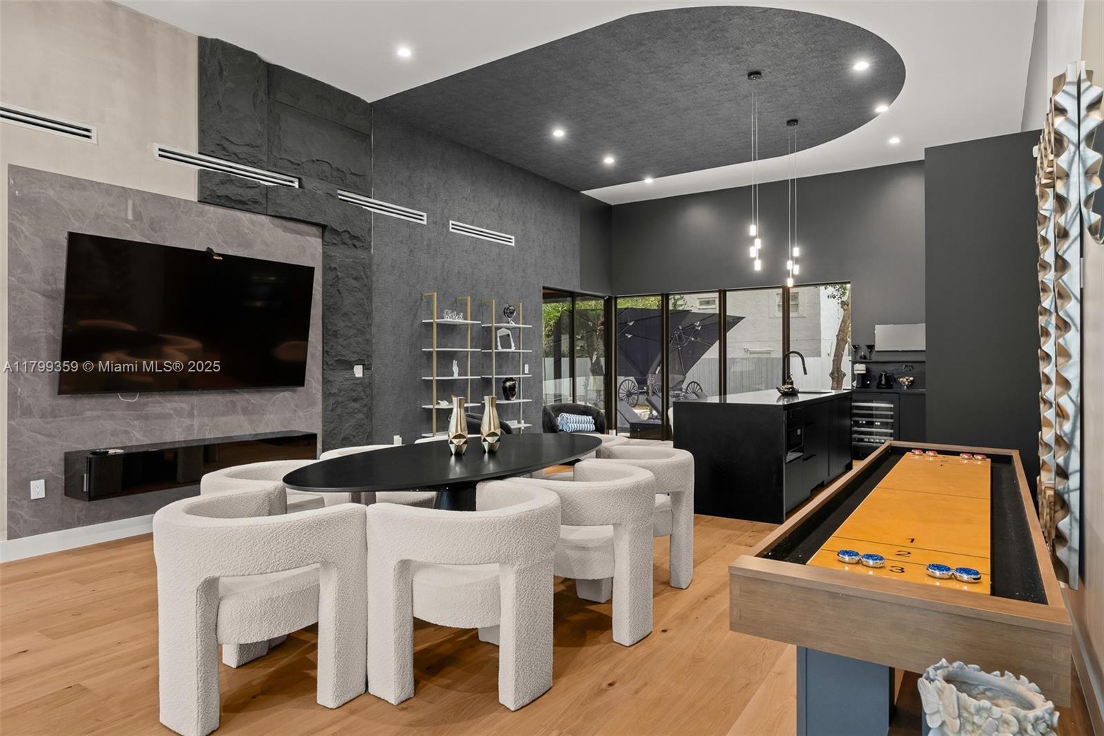 A modern game room features a shuffleboard table, dining area, and dark stone accent walls — 400 NW 49th St # 0, Miami FL 33127, MIAMI, FL