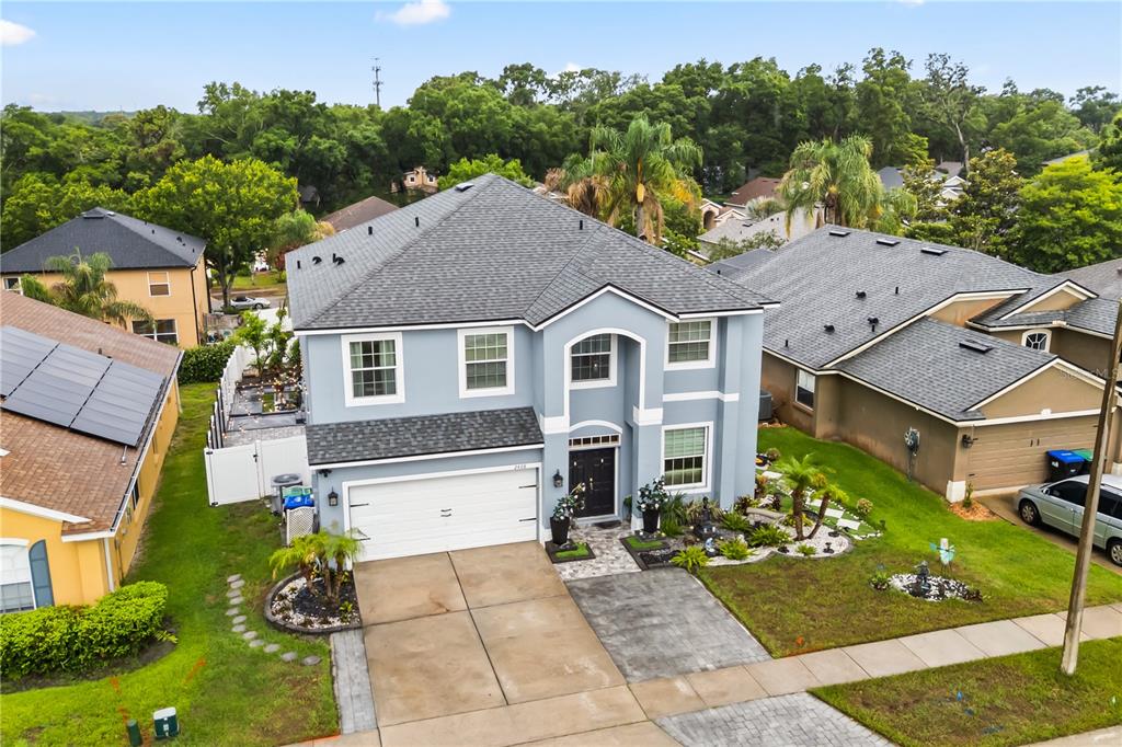An aerial view of a two-story light blue house with a two-car garage — 2408 CIMMARON ASH WAY, APOPKA, FL