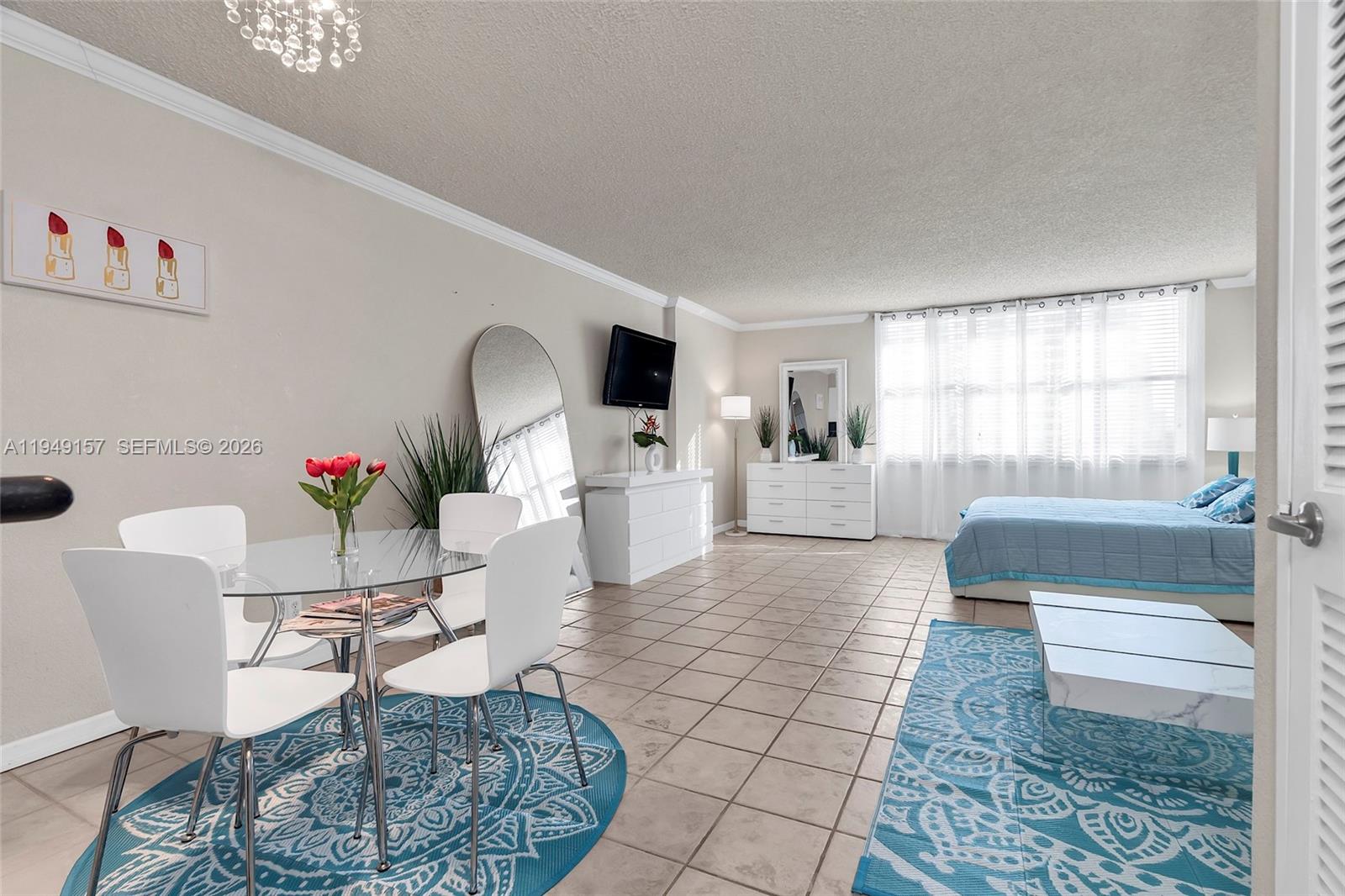 A studio apartment features a dining area, a bed, and tiled floors throughout — 2501 S Ocean Dr # 534, Hollywood FL 33019, HOLLYWOOD, FL
