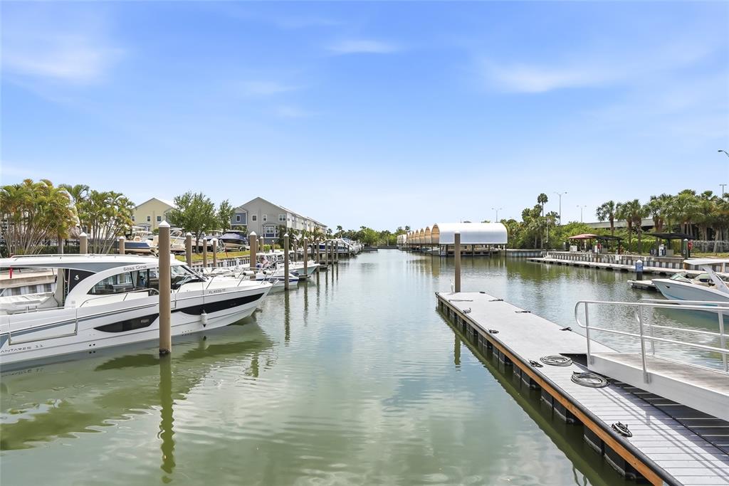 A marina with docked boats and a floating pier under a clear blue sky — 3162 MOORINGS DRIVE, ST PETERSBURG, FL