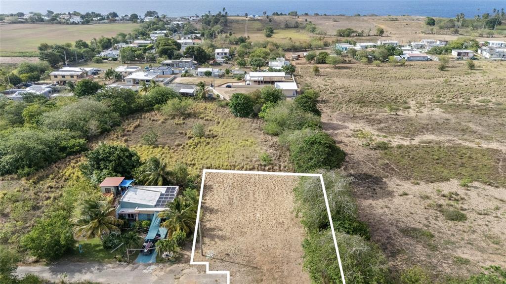An aerial view shows a vacant rectangular lot outlined in white next to a house — PR 459 KM13.3 Bo. Bejucos INT CALLE LAS UVAS, ISABELA, PR