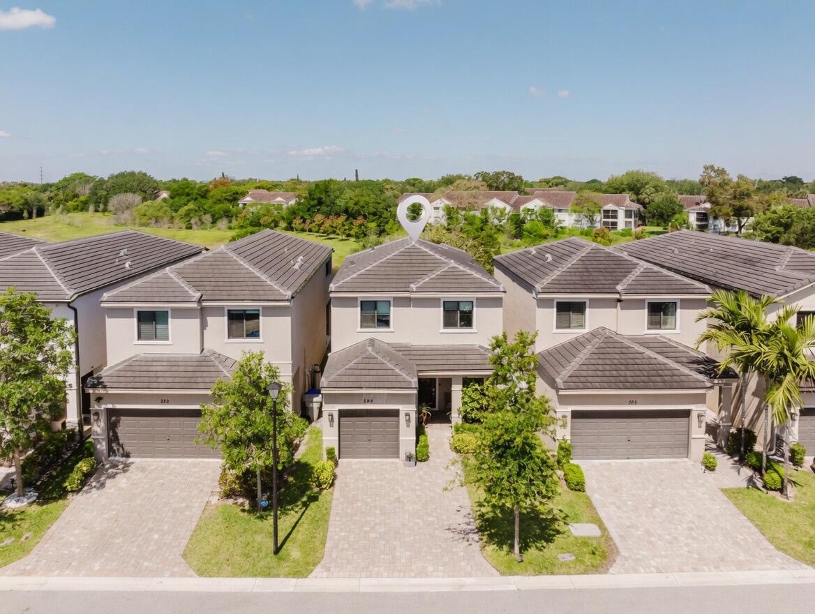 An aerial view shows a row of three two-story suburban houses with gray tiled roofs — 295 NW 33rd Lane, Pompano Beach FL 33069, POMPANO BEACH, FL