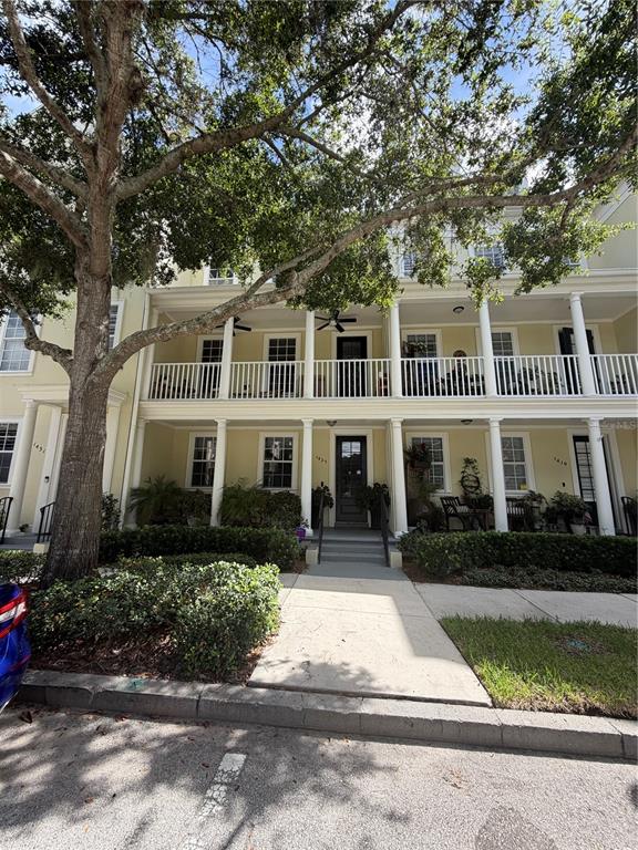 A three-story townhouse with a front porch, balcony, and white columns — 1425 CHATFIELD PLACE, ORLANDO, FL