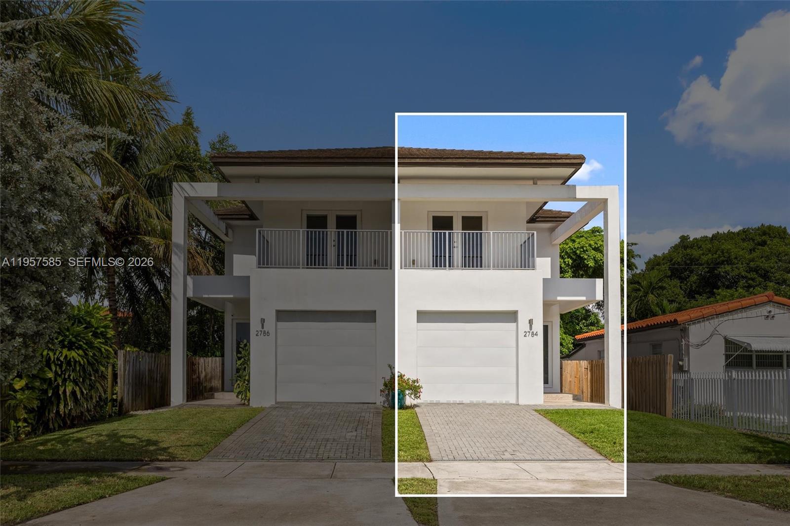 A two-story duplex features white stucco walls, a paved driveway, and a second-floor balcony — 2784 SW 34th Ave, Miami FL 33133, MIAMI, FL
