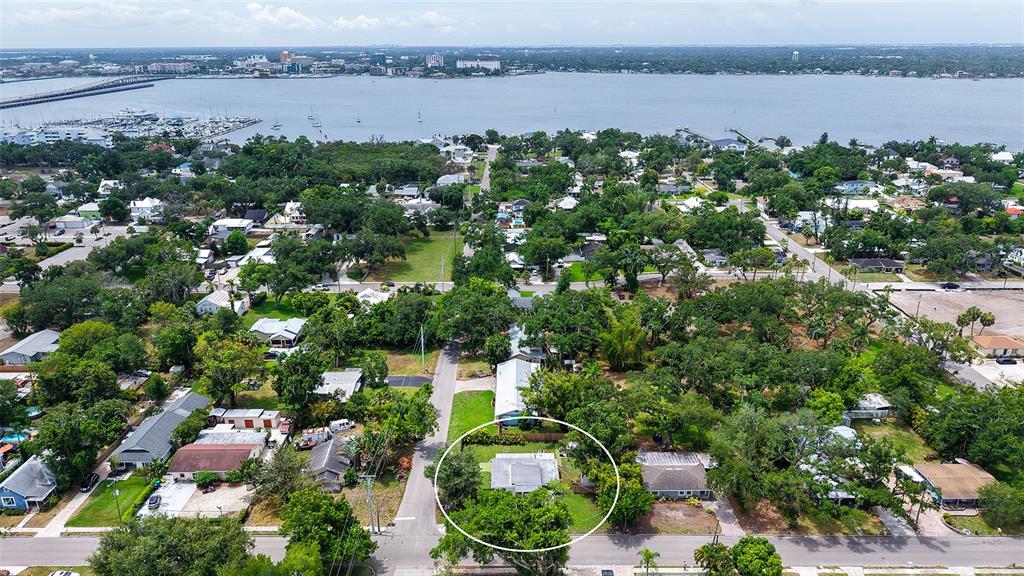 An aerial view shows a residential neighborhood with a circled house near a large body — 1301 6TH STREET W, PALMETTO, FL