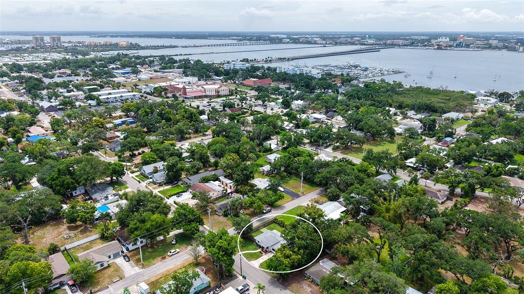 An aerial view shows a residential neighborhood with a house circled in white — 1301 6TH STREET W, PALMETTO, FL