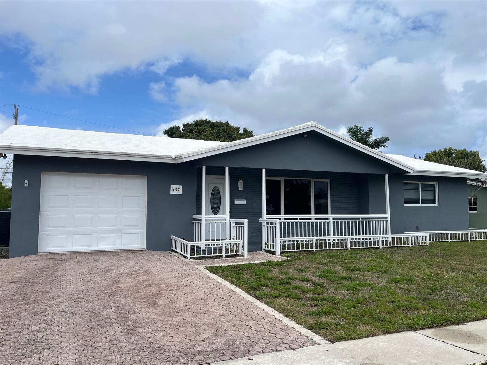 A single-story house with a gray exterior, white roof, and a white front porch railing — 257 SW 5th Street, Boca Raton FL 33432, BOCA RATON, FL