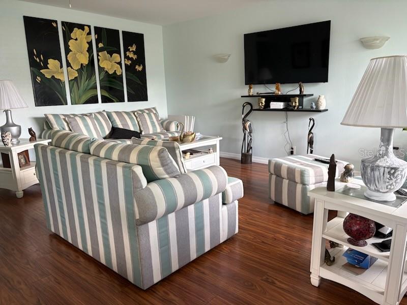 A side view of a one-story building with a light green mansard roof — 101 CAMBRIDGE TRAIL UNIT 200, SUN CITY CENTER, FL