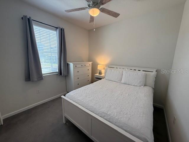 A bedroom features a white bed, a matching dresser, and a ceiling fan — 360 BUCHANNAN DRIVE, DAVENPORT, FL