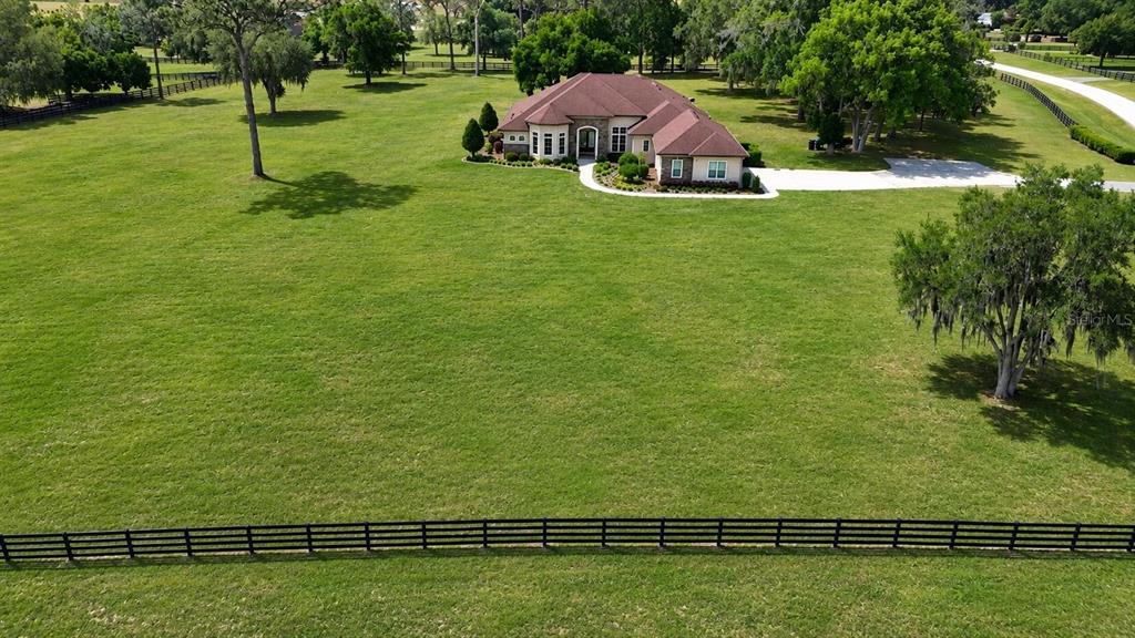 An aerial view shows a single-story house with a brown roof on a large grassy lot — 1145 NW 63RD COURT, OCALA, FL