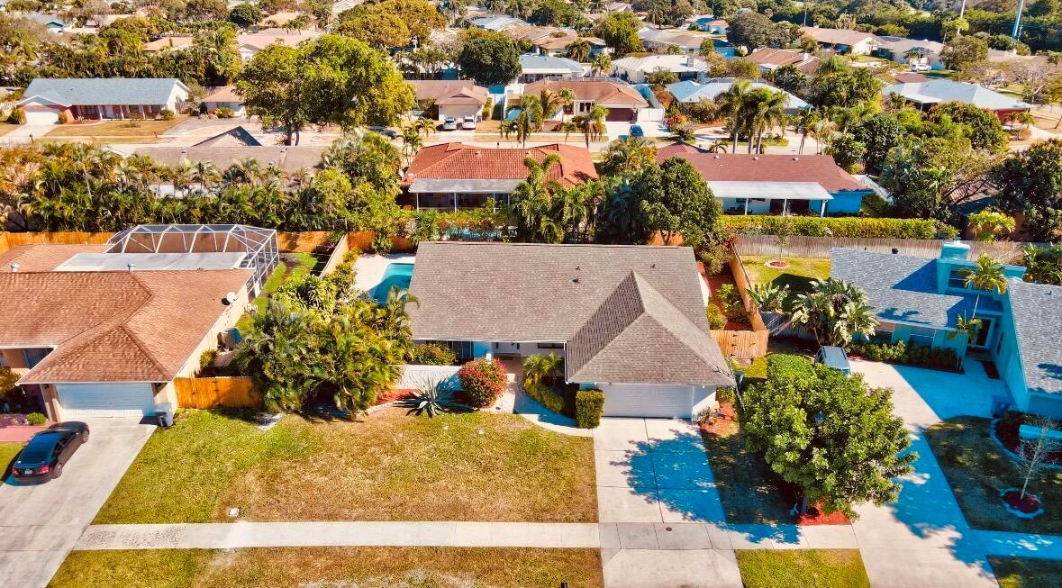 An aerial view of a suburban neighborhood featuring houses with pools and manicured lawns — 17768 Maplewood Drive, Boca Raton FL 33487, BOCA RATON, FL