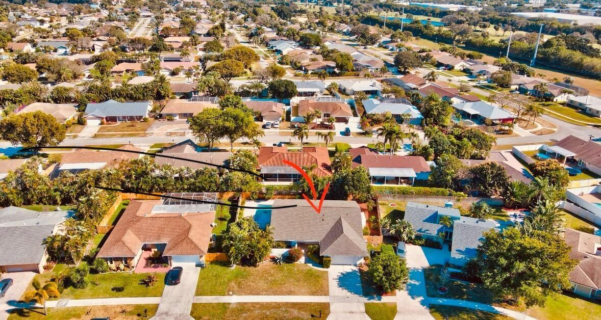 An aerial view of a suburban house with a swimming pool and a shingled roof — 17768 Maplewood Drive, Boca Raton FL 33487, BOCA RATON, FL