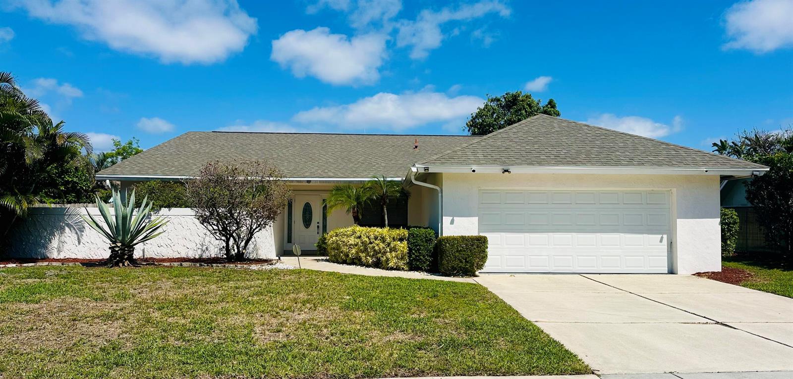 A single-story house with a white exterior, a two-car garage, and a landscaped front yard — 17768 Maplewood Drive, Boca Raton FL 33487, BOCA RATON, FL