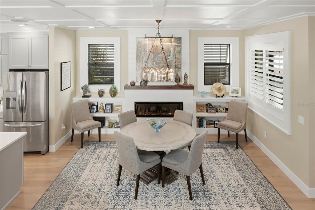 A dining area features a round table, four chairs, a fireplace, and built-in shelving — 2344 2ND AVENUE N, ST PETERSBURG, FL
