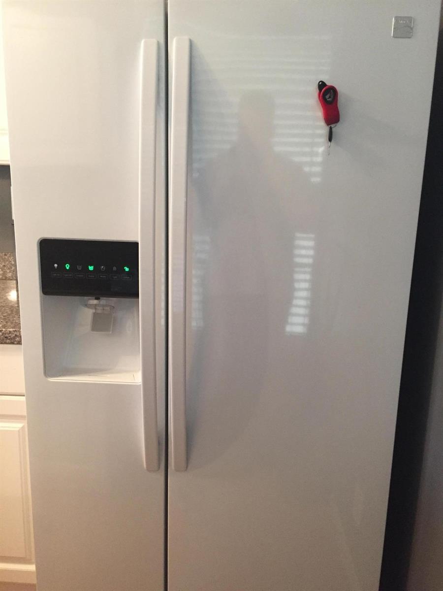 A white side-by-side refrigerator with an integrated water and ice dispenser stands in a kitchen — 10 Royal Palm Way # 2030, Boca Raton FL 33432, BOCA RATON, FL