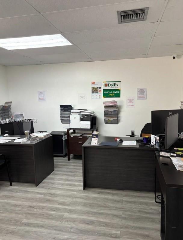 An office space features two dark wood desks, a printer, and wall-mounted document organizers — 2026 SW 1st St, Miami FL 33135, MIAMI, FL