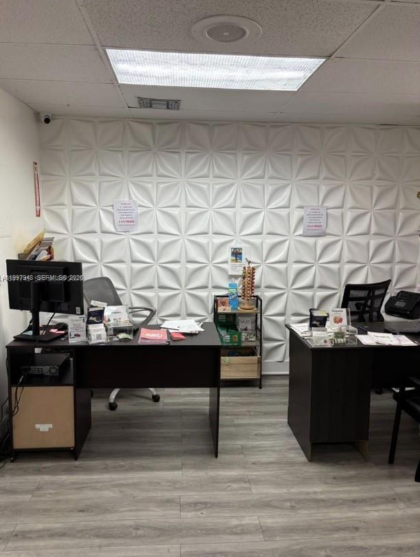 An office space features two desks, chairs, and a white geometric textured accent wall — 2026 SW 1st St, Miami FL 33135, MIAMI, FL