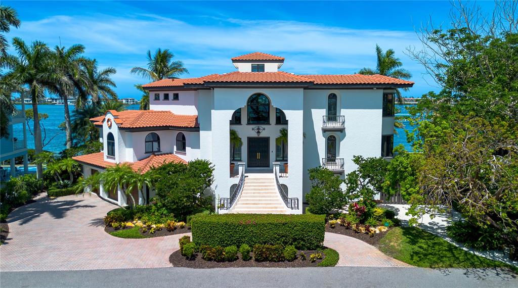 A large white Mediterranean-style house with a tile roof and a grand front staircase — 12925 42ND TERRACE W, CORTEZ, FL