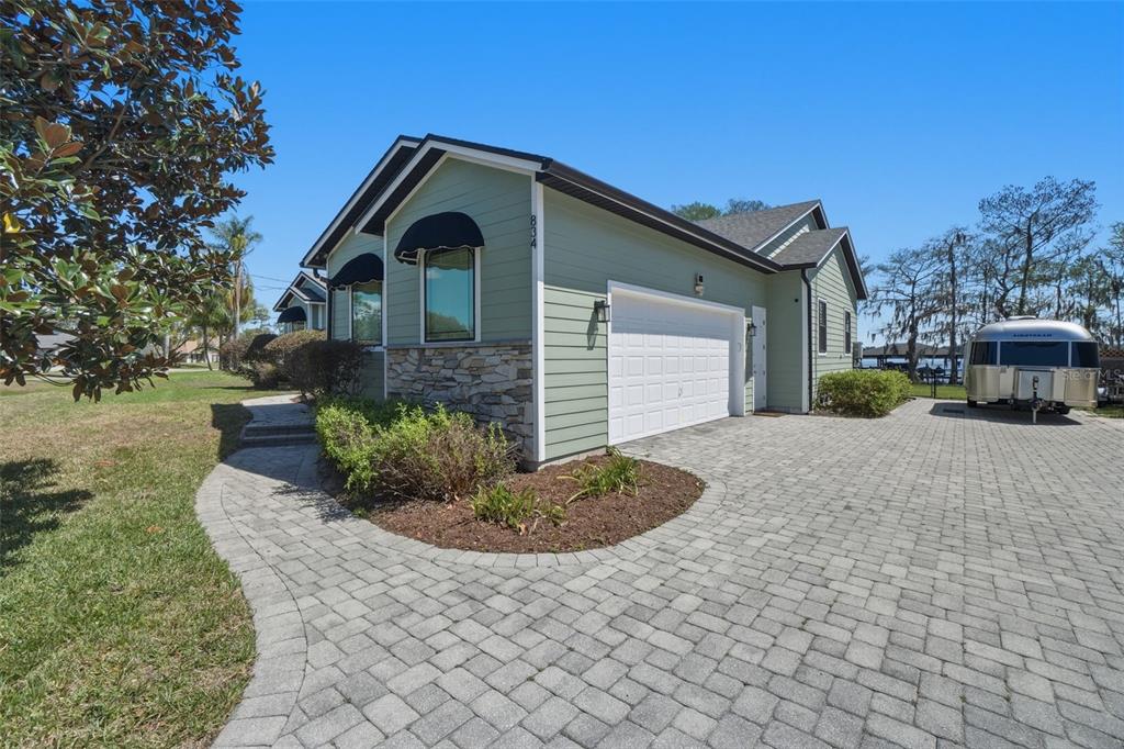 An aerial view shows a house with a red location pin beside a lake — 834 MILLSHORE DRIVE, CHULUOTA, FL