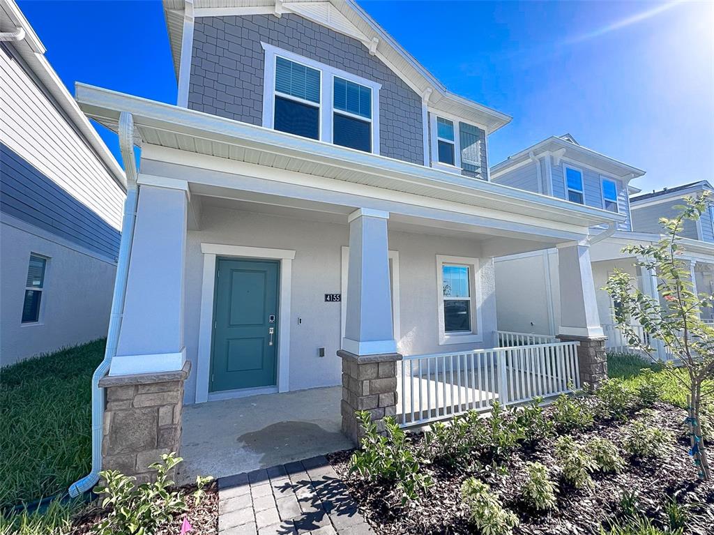 A two-story house features a front porch with stone pillars and a teal front door — 4155 CONJUNCTION WAY, APOPKA, FL