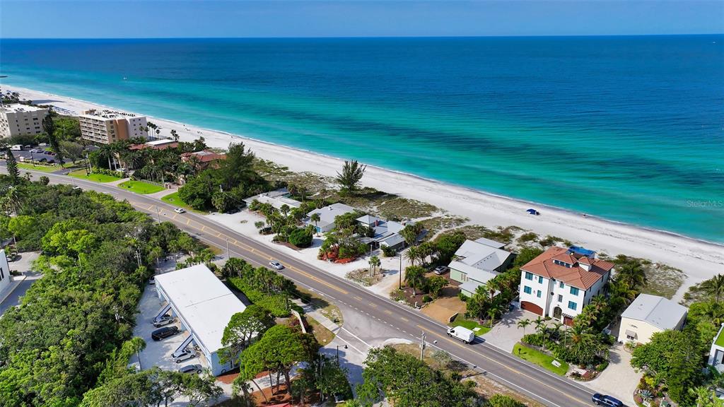 An aerial view shows a coastal road running parallel to a sandy beach and ocean — 2850 GULF OF MEXICO DRIVE UNIT 4, LONGBOAT KEY, FL