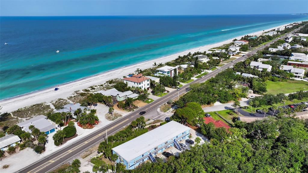 An aerial view shows a coastal road running parallel to a beach and ocean — 2850 GULF OF MEXICO DRIVE UNIT 4, LONGBOAT KEY, FL