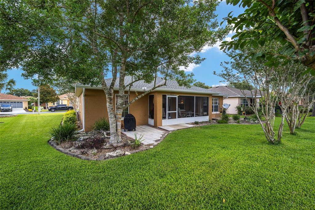The exterior view shows a house with a screened-in patio and a large grassy yard — 7962 SW 83RD PLACE, OCALA, FL