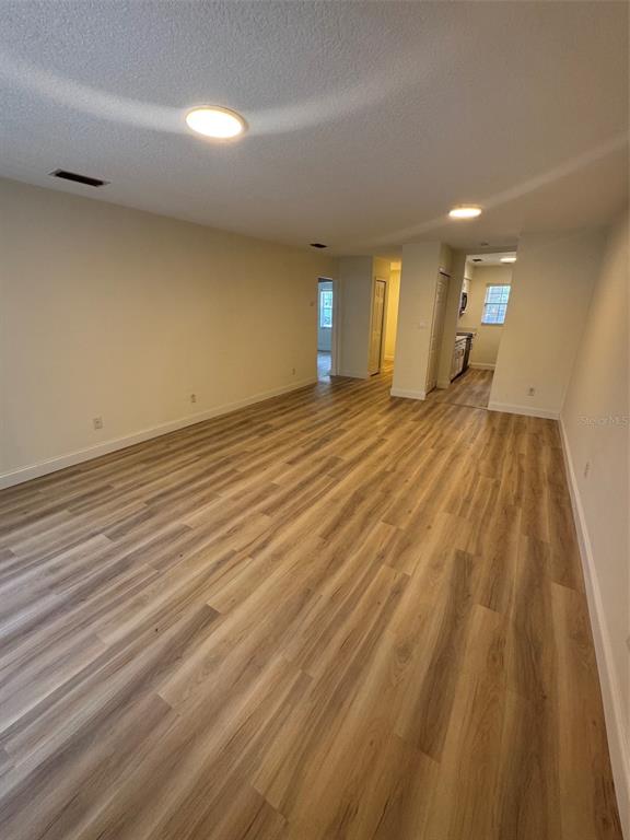 A kitchen features white shaker cabinets, a stainless steel dishwasher, and light-colored countertops — 2317 SUN VALLEY CIRCLE UNIT 2317, WINTER PARK, FL
