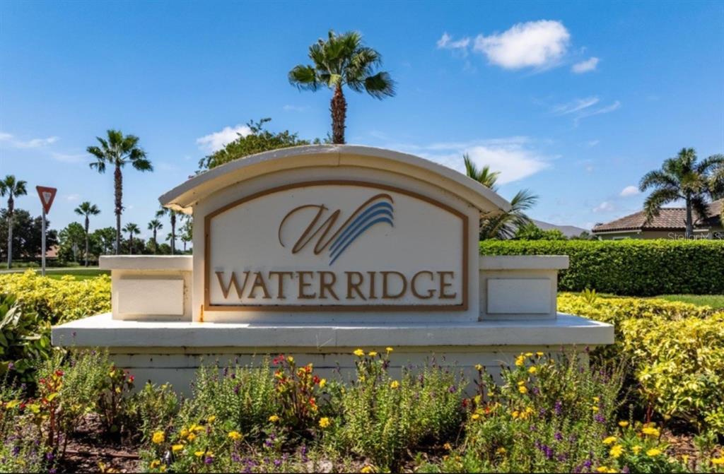 A stone monument sign for Water Ridge stands in front of palm trees and landscaping — 433 WATERFERN TRAIL DRIVE, AUBURNDALE, FL