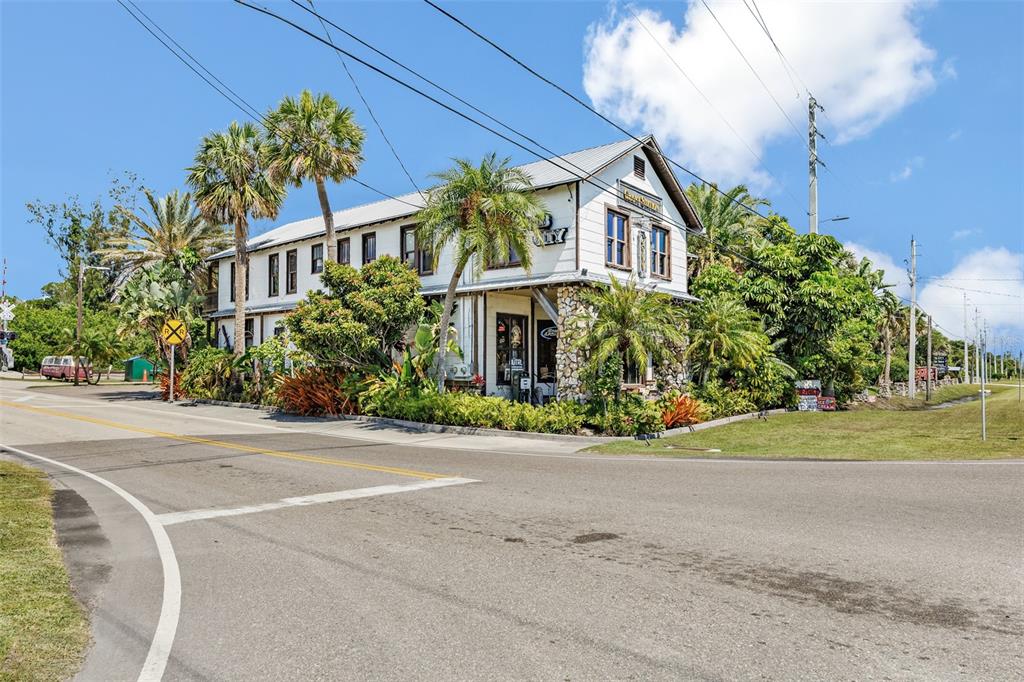 A two-story white building with a stone base sits at a road intersection — 5390 HIGHWAY 1, GRANT VALKARIA, FL