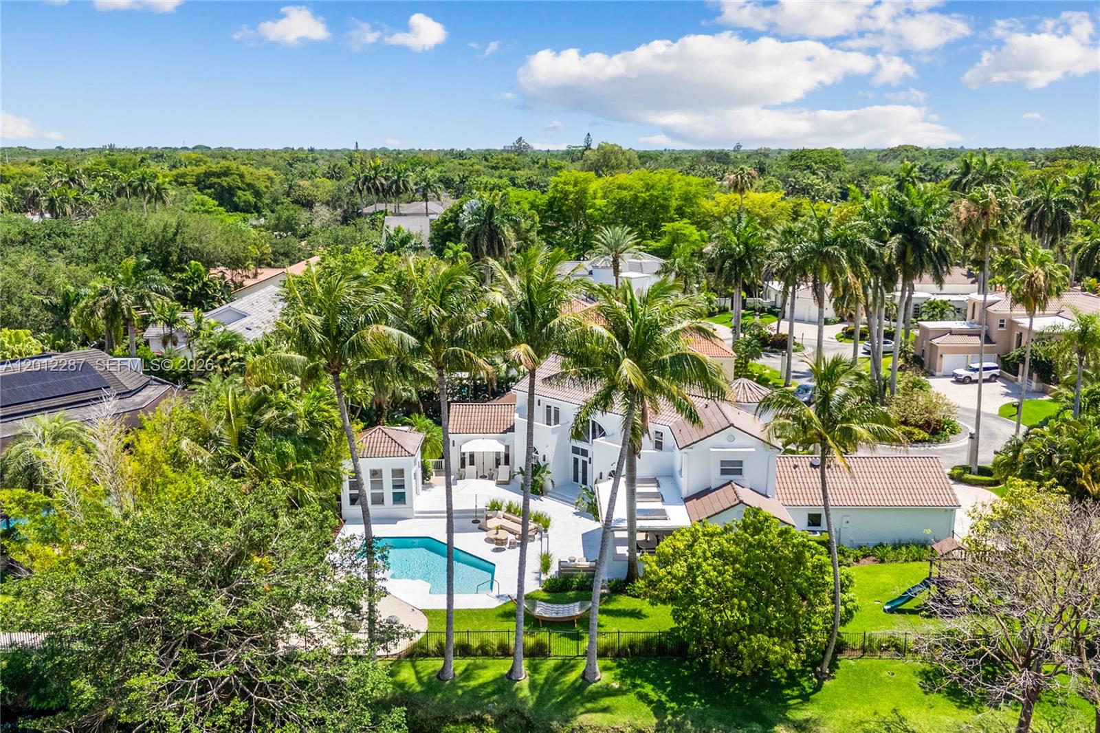 An aerial view shows a white two-story house with a pool and palm trees — 8763 SW 61st Pl, Pinecrest FL 33156, PINECREST, FL