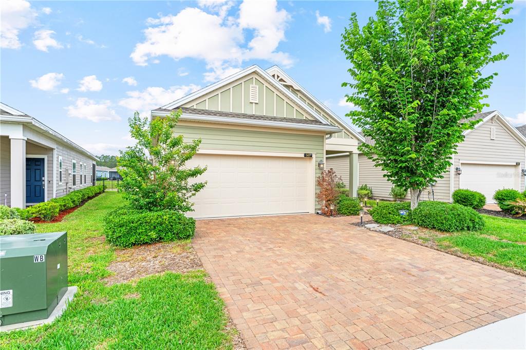 A light green house with a two-car garage and a paved driveway — 507 TYNES BOULEVARD, MIDDLEBURG, FL