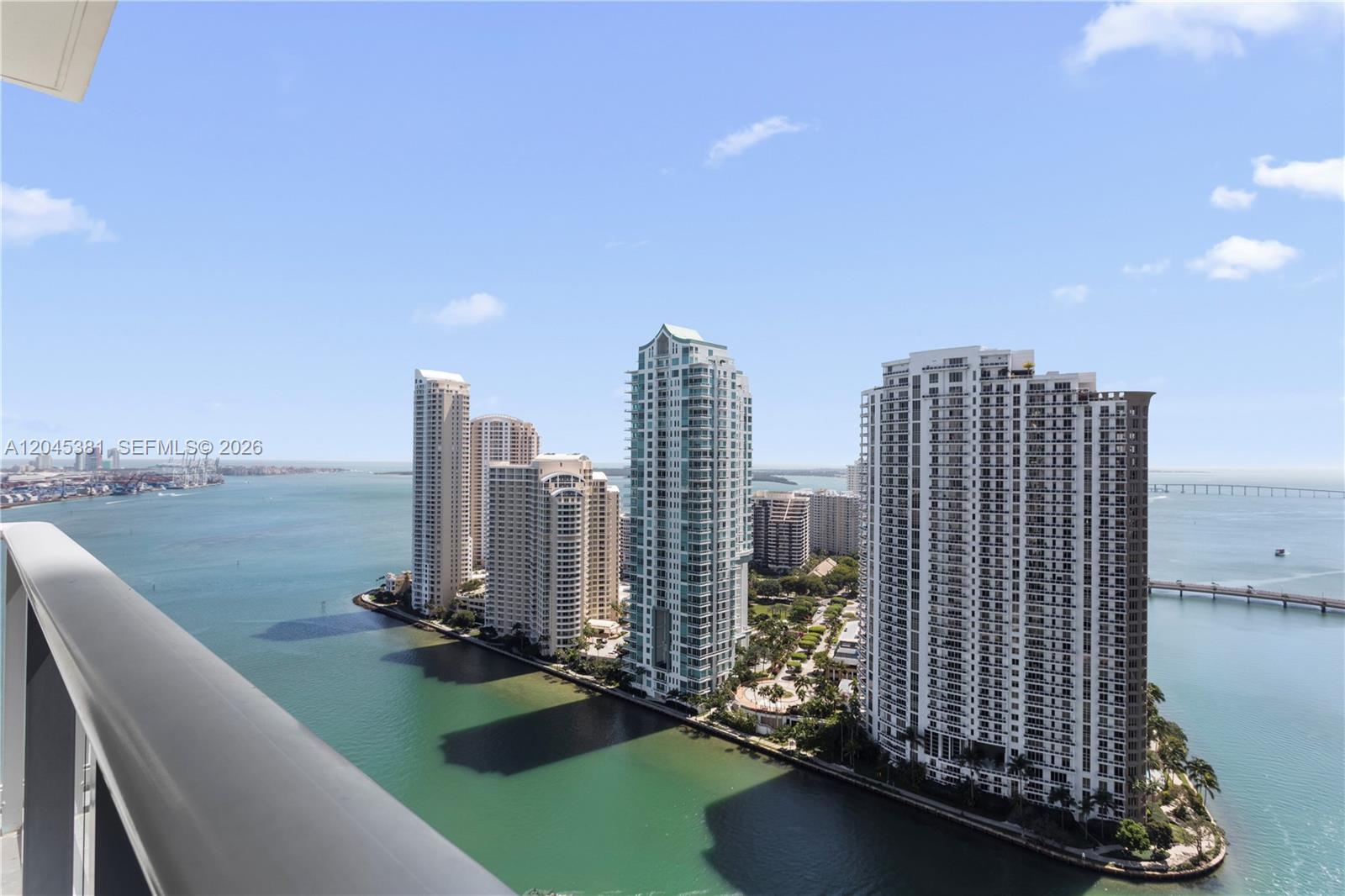 An elevated view shows several high-rise residential buildings situated on a waterfront peninsula — 300 S Biscayne Blvd # 2806, Miami FL 33131, MIAMI, FL