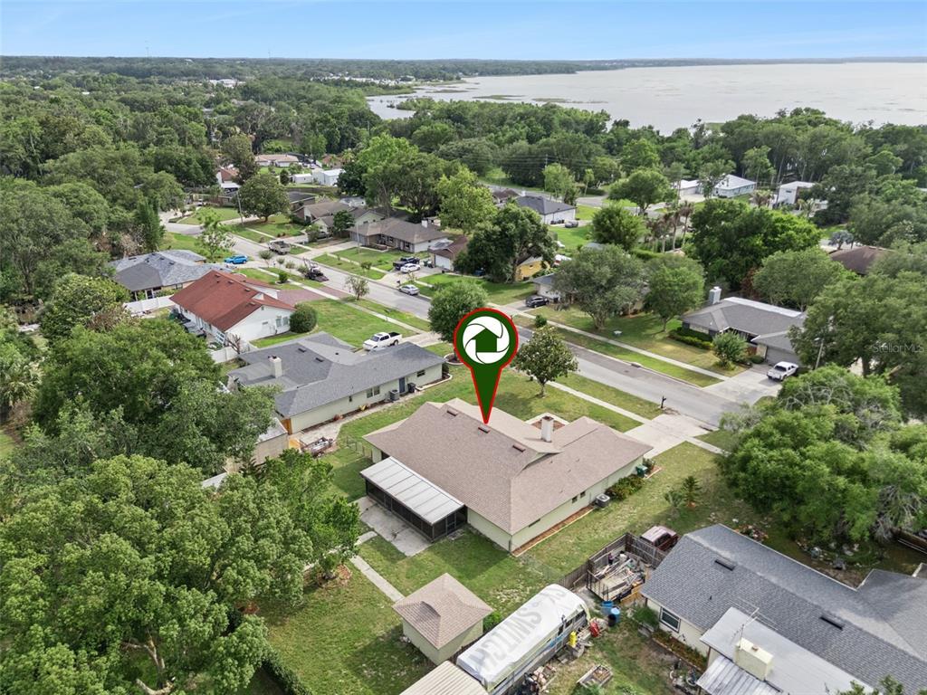 An aerial view shows a single-story house with a screened patio and a detached shed — 1503 COLUSO DRIVE, WINTER GARDEN, FL