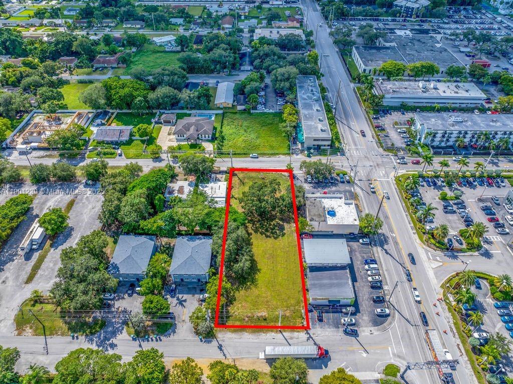 An aerial view shows a rectangular vacant lot outlined in red between two commercial buildings — 137 NW 165th St, Miami FL 33169, MIAMI, FL