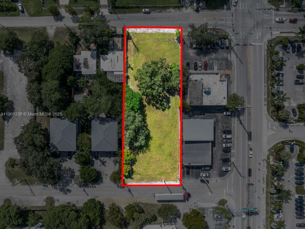 An aerial view shows a rectangular, vacant lot outlined in red between two buildings — 137 NW 165th St, Miami FL 33169, MIAMI, FL
