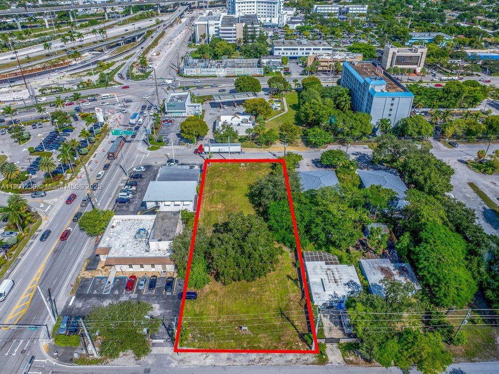 An aerial view shows a rectangular vacant lot outlined in red next to commercial buildings — 137 NW 165th St, Miami FL 33169, MIAMI, FL