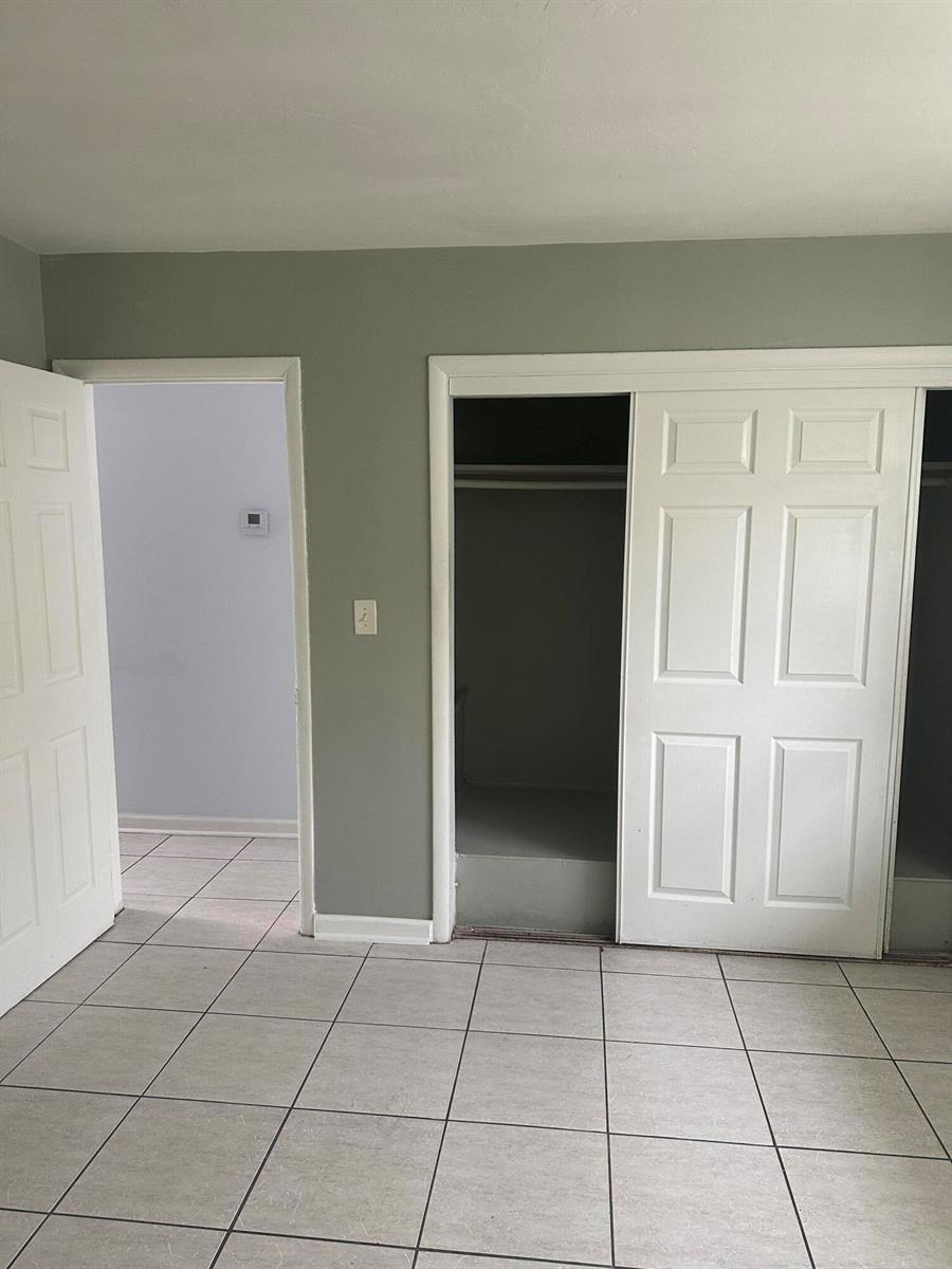 A room with light gray walls, tiled flooring, an open doorway, and a white closet — 3194 Prince Drive # 3196, Lake Worth FL 33461, LAKE WORTH, FL
