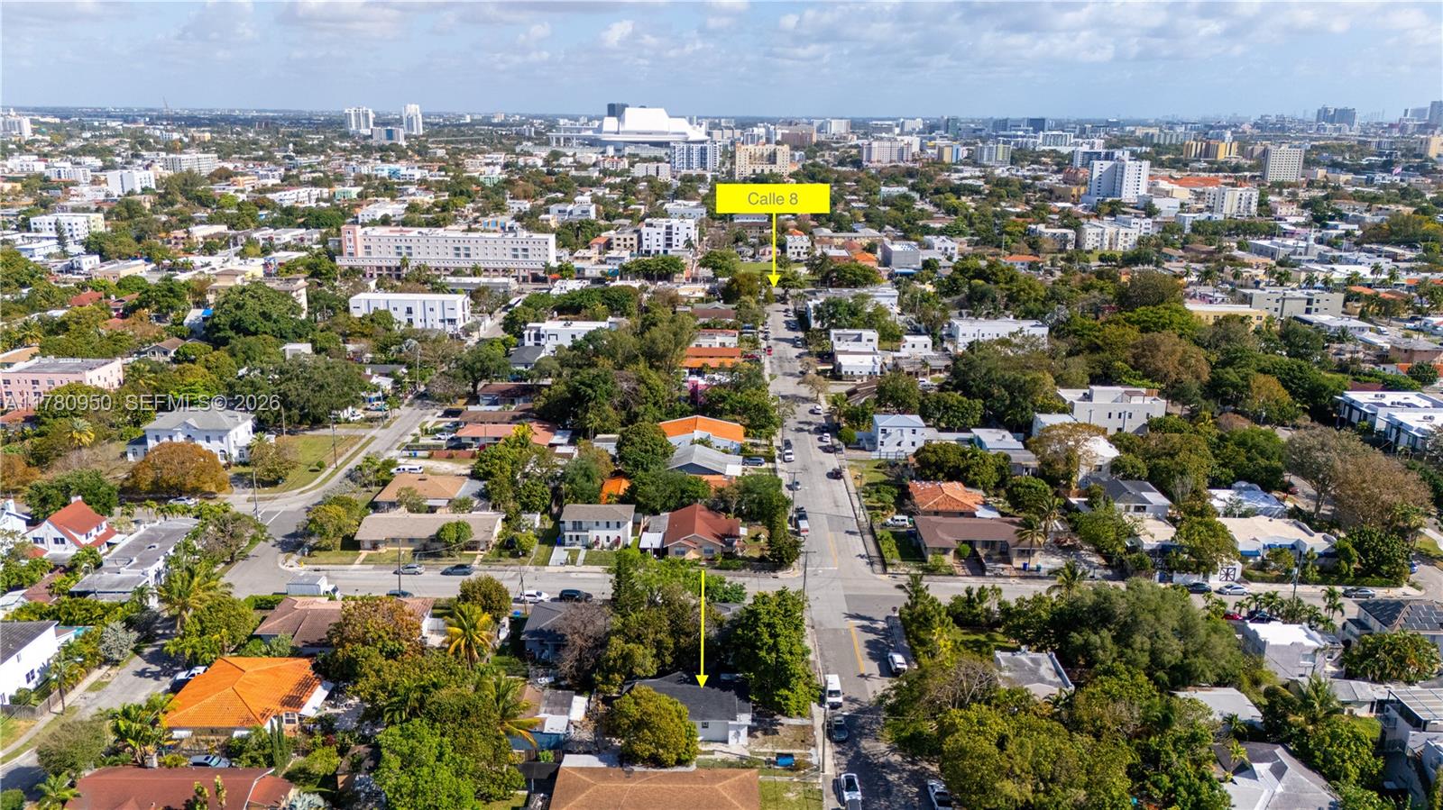 An aerial view shows a residential neighborhood with a street leading toward a city skyline — 1114 SW 13th Ct, Miami FL 33135, MIAMI, FL