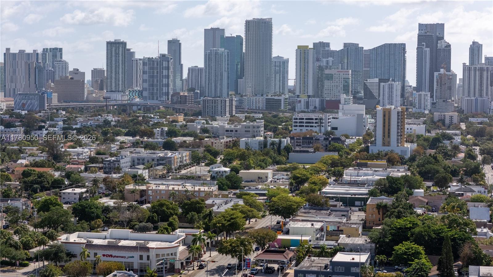 An elevated view of a city skyline featuring numerous high-rise buildings above low-density residential areas — 1114 SW 13th Ct, Miami FL 33135, MIAMI, FL