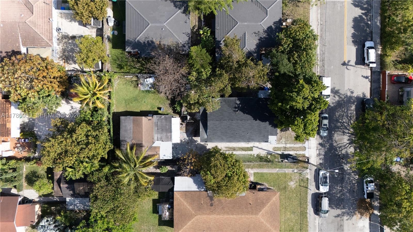 An aerial view shows several residential houses with driveways, trees, and parked cars on a street — 1114 SW 13th Ct, Miami FL 33135, MIAMI, FL
