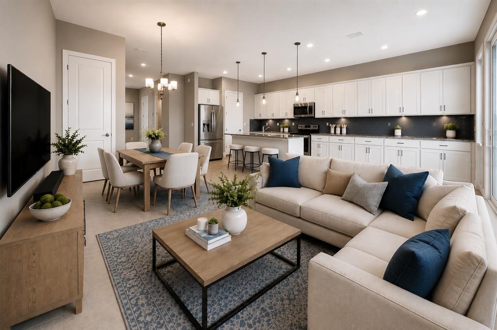 An open-concept living room, dining area, and kitchen with white cabinetry and neutral furnishings — 13043 SERENE GLADE ROAD, WINTER GARDEN, FL