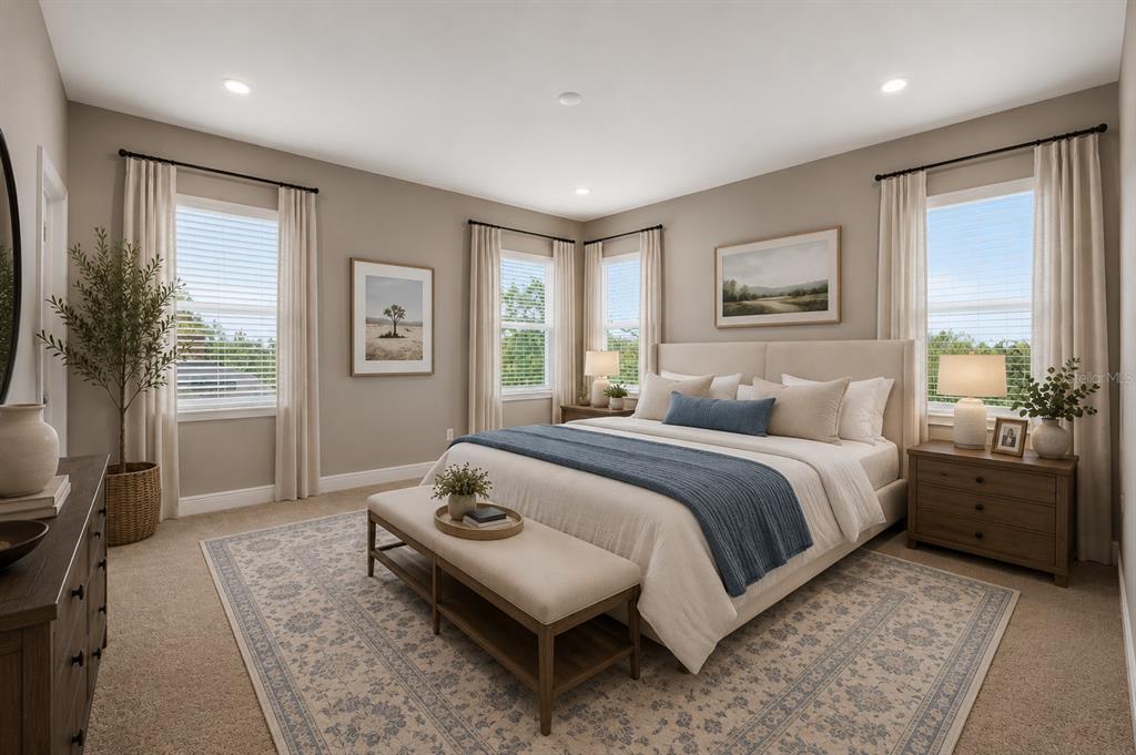 A bedroom features a king bed, a bench, two nightstands, and windows with neutral curtains — 13043 SERENE GLADE ROAD, WINTER GARDEN, FL