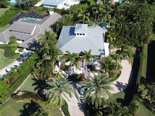 An aerial view shows a house with a metal roof surrounded by palm trees — 17433 SE Indian Hills Dr # 17433, Jupiter FL 33469, JUPITER, FL