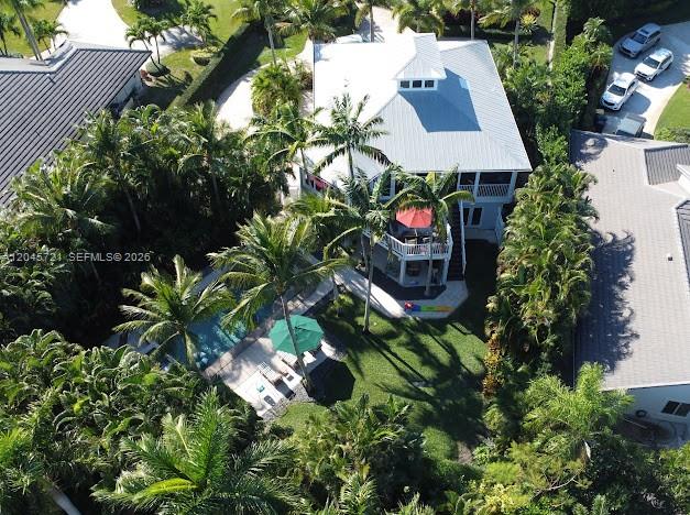 An aerial view shows a house with a white roof, pool, and surrounding palm trees — 17433 SE Indian Hills Dr # 17433, Jupiter FL 33469, JUPITER, FL